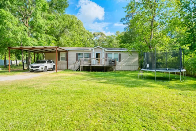 a view of a house with a yard patio and swimming pool