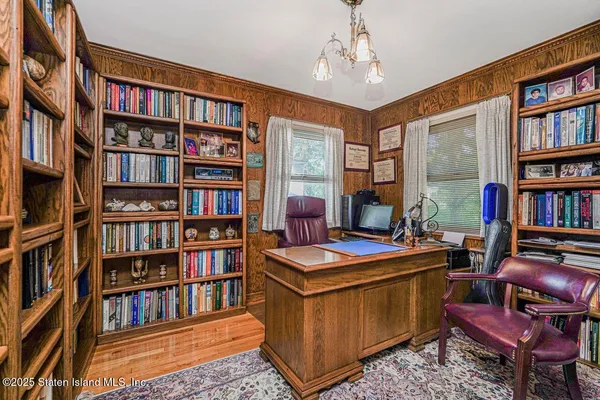 a view of a workspace with bookshelf