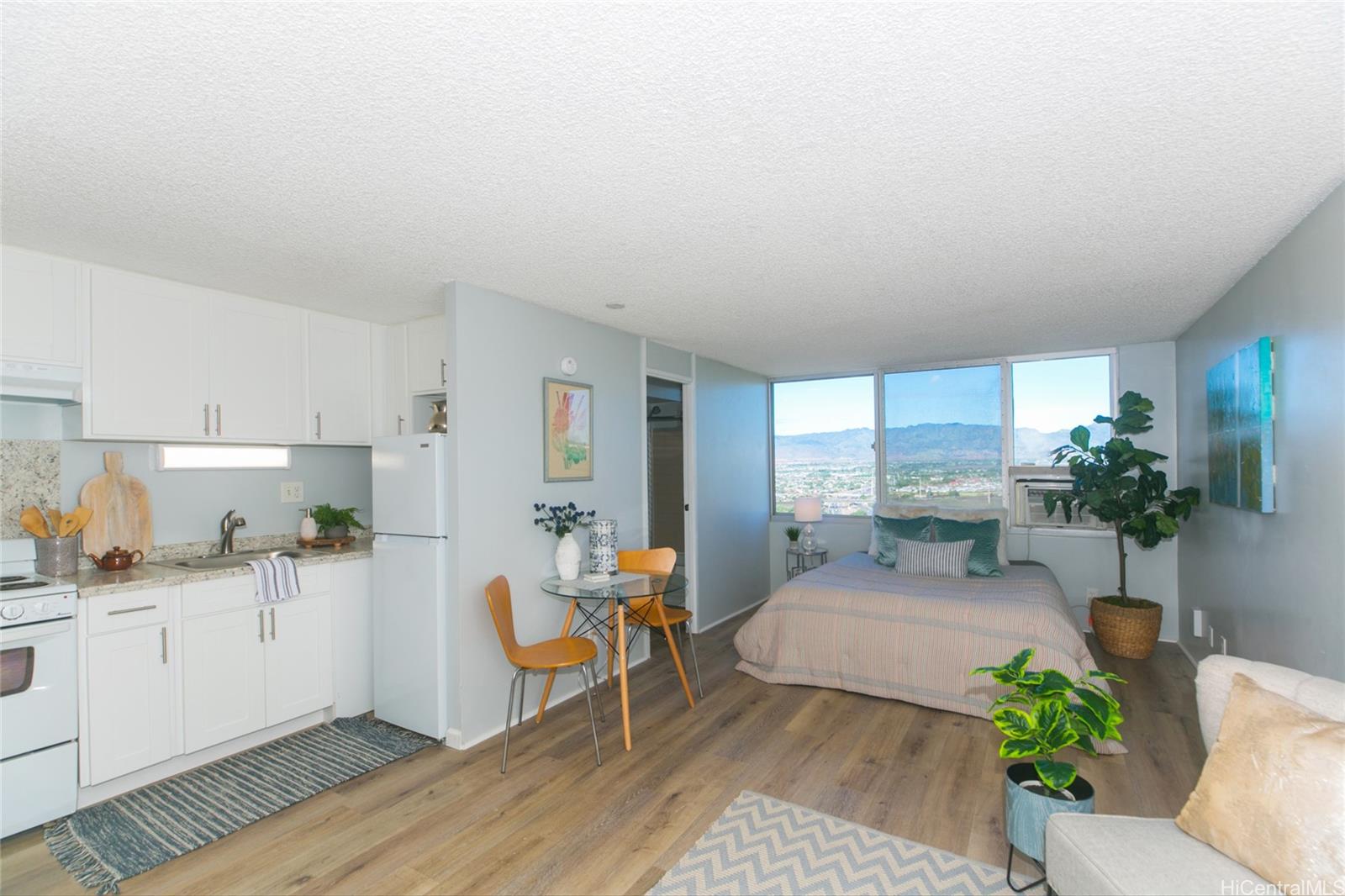 1060 Kamehameha Highway, Unit 3301A Pearl City, HI 96782 - Photo 1 of 1 a living room with furniture and potted plants