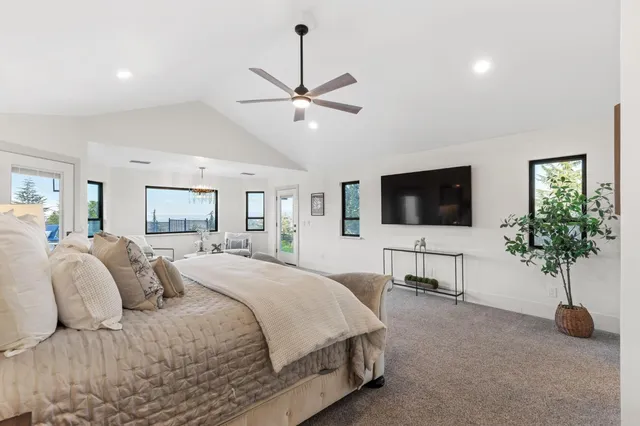 a bedroom with a large bed and a window