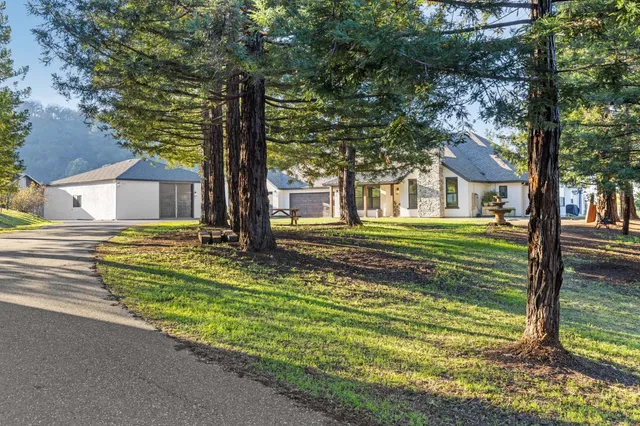 a front view of a house with a yard table and chairs