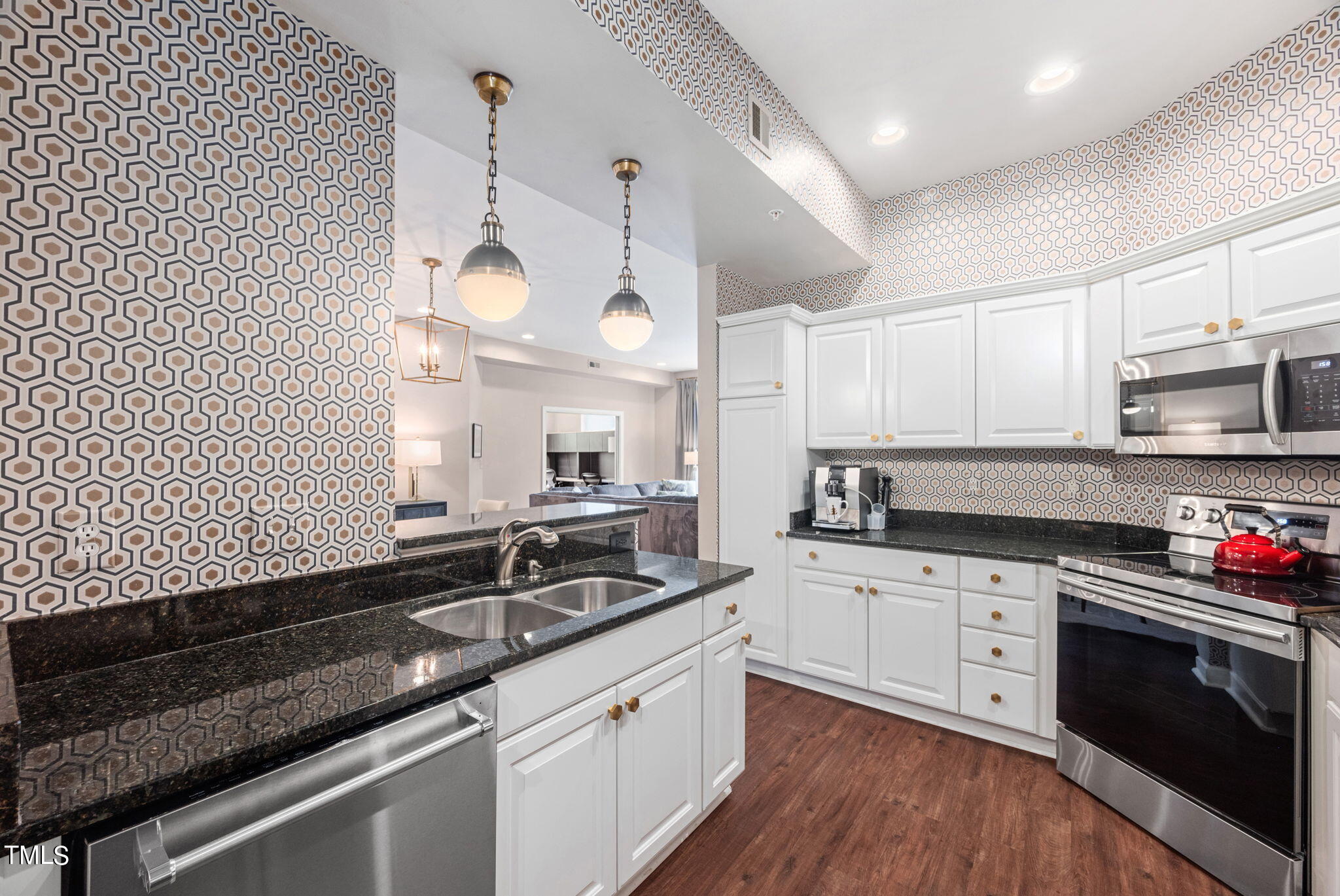200 South Dawson Street, Unit 201 Raleigh, NC 27601 - Photo 16 of 39 a kitchen with a sink dishwasher a stove and white cabinets with wooden floor