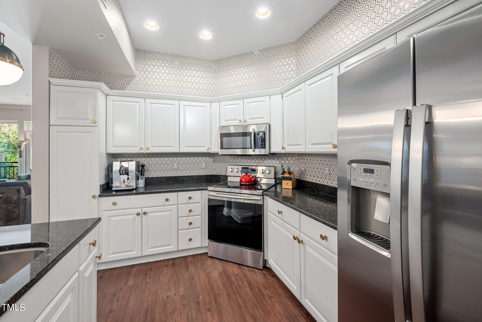 200 South Dawson Street, Unit 201 Raleigh, NC 27601 - Photo 18 of 39 a kitchen with granite countertop white cabinets and stainless steel appliances