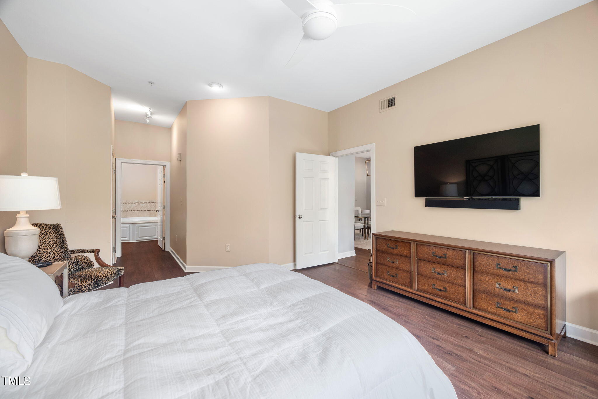 200 South Dawson Street, Unit 201 Raleigh, NC 27601 - Photo 21 of 39 a bedroom with a bed and a flat screen tv