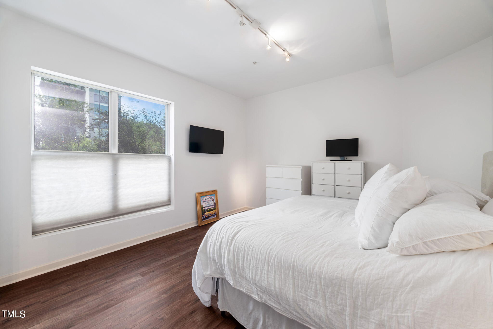 200 South Dawson Street, Unit 201 Raleigh, NC 27601 - Photo 25 of 39 a bedroom with a bed and a window