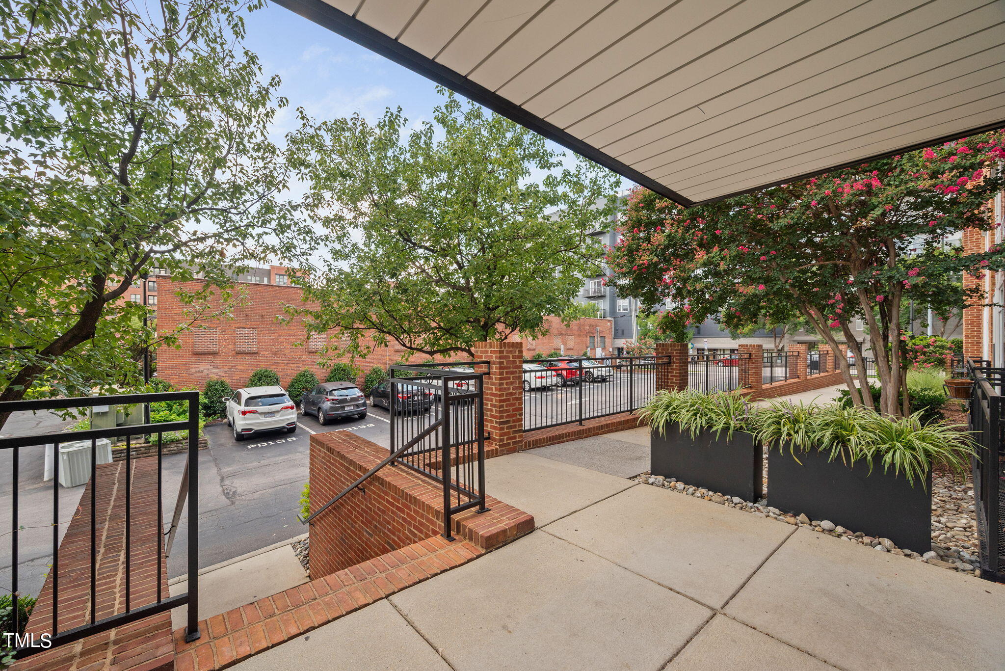 200 South Dawson Street, Unit 201 Raleigh, NC 27601 - Photo 5 of 39 a patio with table and chairs and potted plants