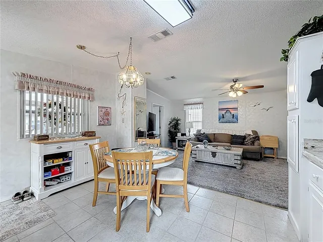 a living room with fireplace furniture and a chandelier