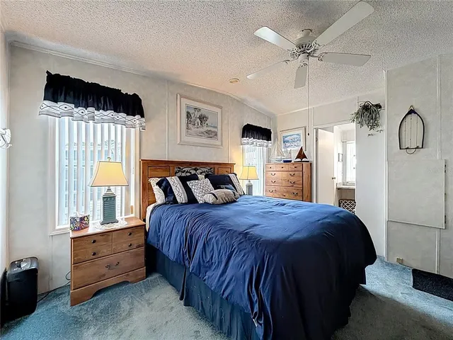 a spacious bedroom with a bed and a window