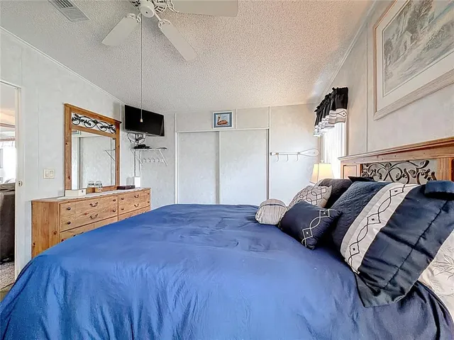 a bed room with a bed and a tv