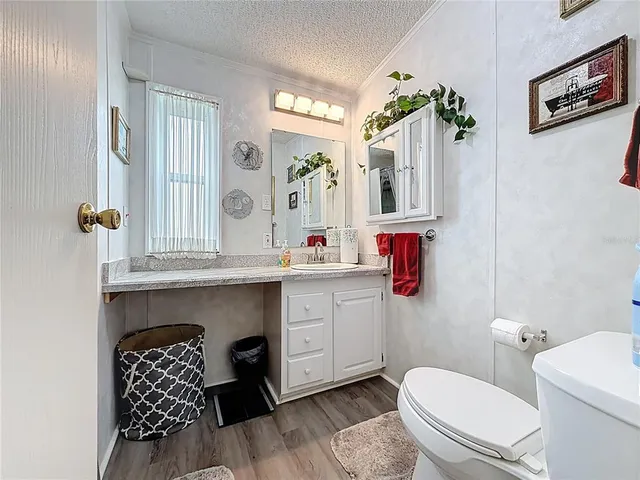 a bathroom with a toilet a sink and a mirror