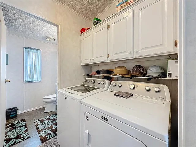 a kitchen with a stove and white cabinets