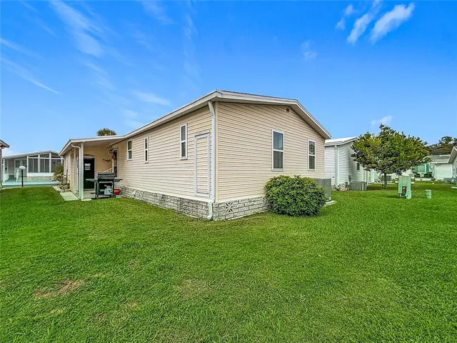 a view of a house with a backyard