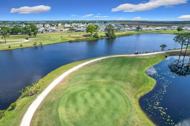 an aerial view of a residential houses with outdoor space and swimming pool