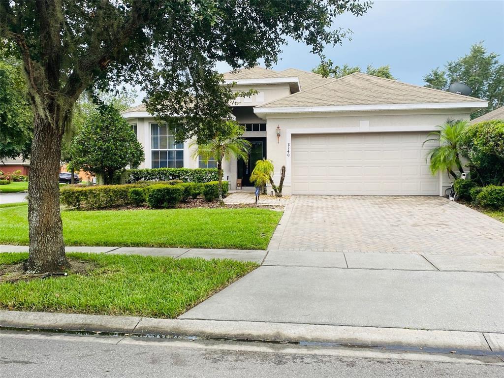 8140 Tumeric Court Orlando, FL 32817 - Photo 1 of 1 a front view of a house with a yard and garage