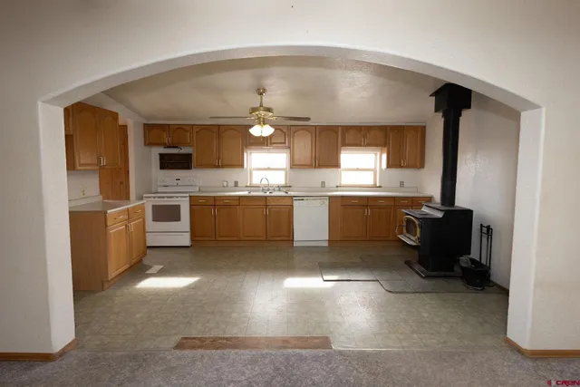 a kitchen with cabinets and chairs