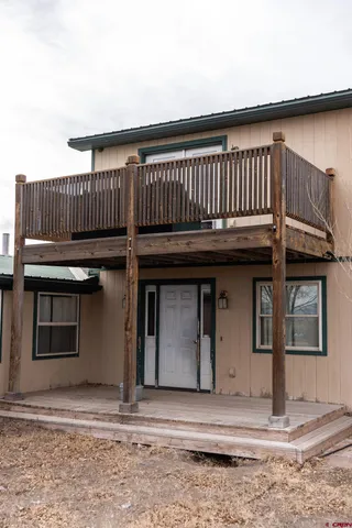 a view of a house with wooden fence