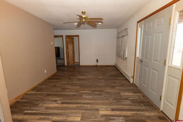 a view of a hallway with wooden floor and closet