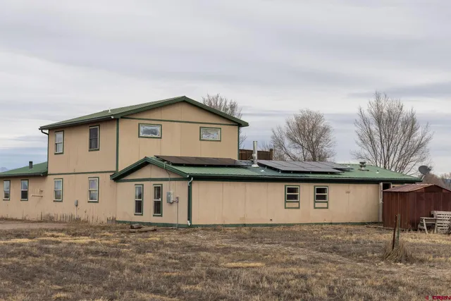 a view of a house with a snow in the yard
