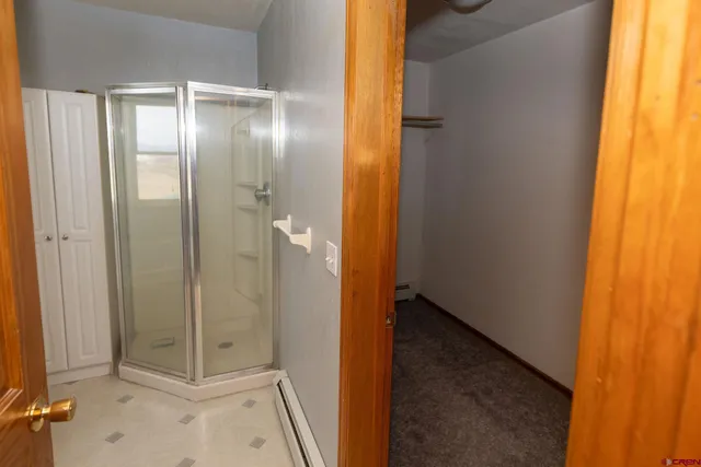 a bathroom with a glass shower door
