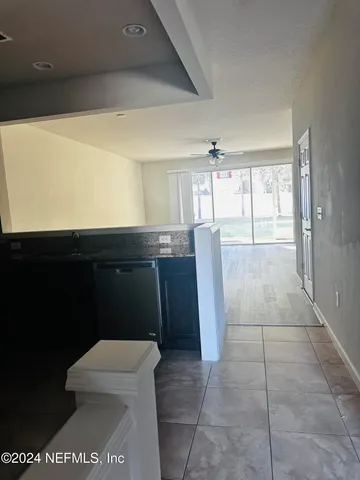 a bathroom with a sink a toilet and large mirror