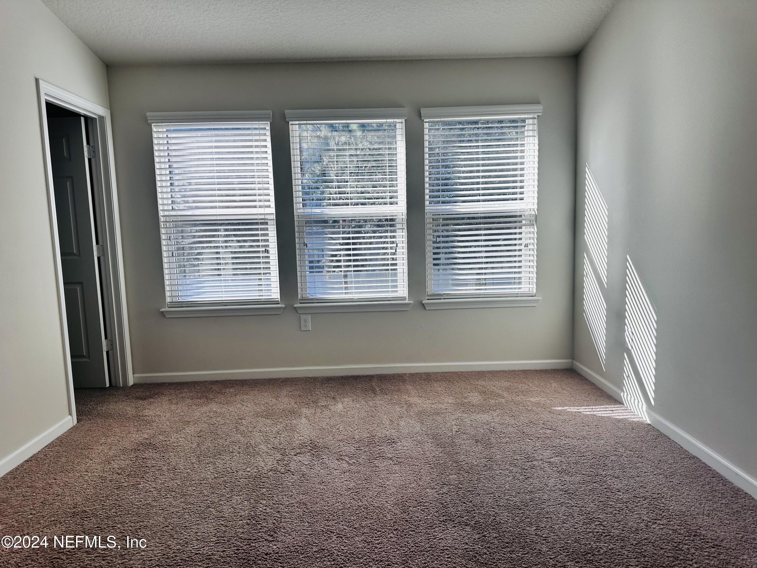 6801 Roundleaf Drive Jacksonville, FL 32258 - Photo 7 of 24 a view of an empty room with a window