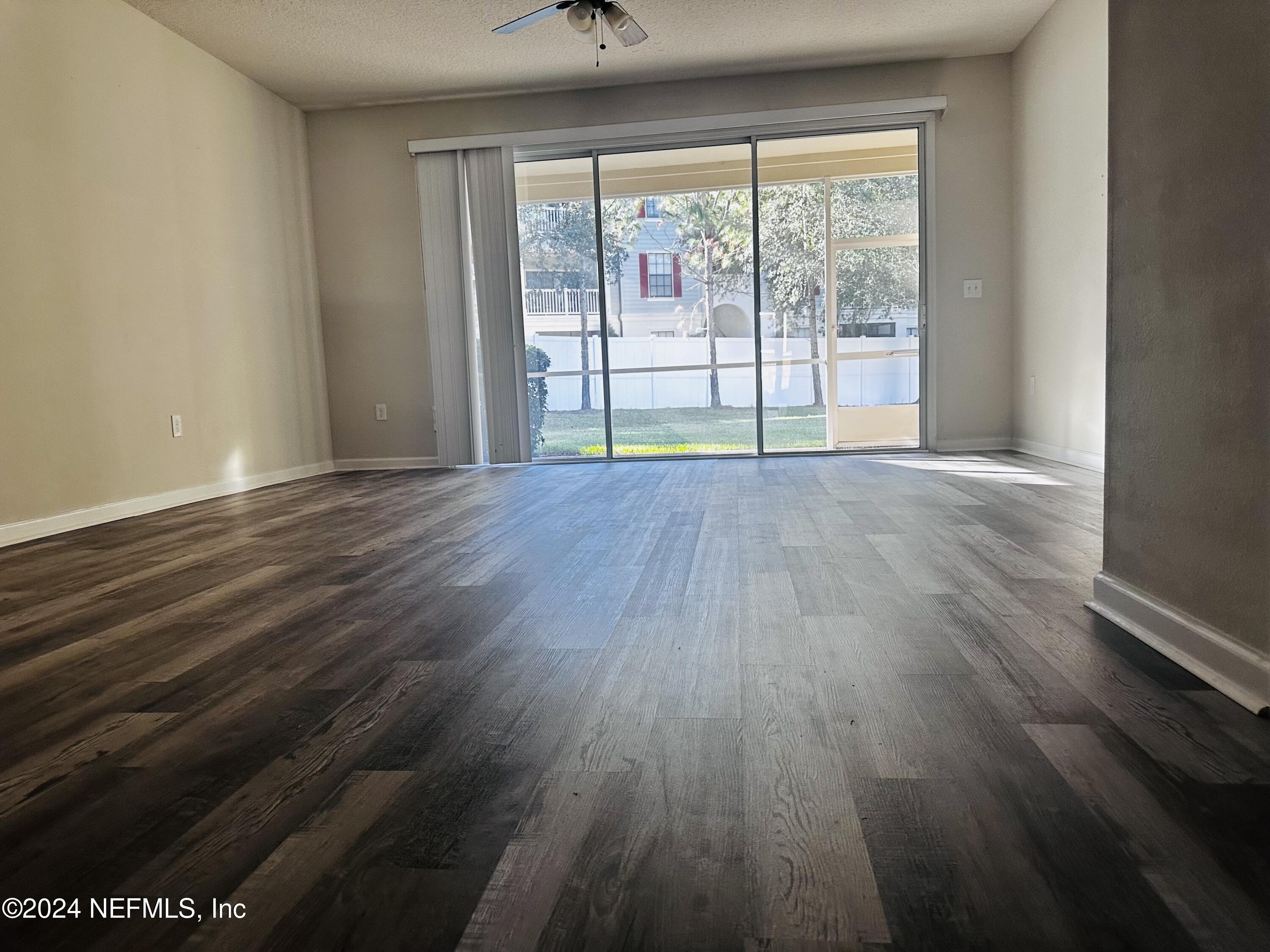 6801 Roundleaf Drive Jacksonville, FL 32258 - Photo 8 of 24 wooden floor in an empty room with a window