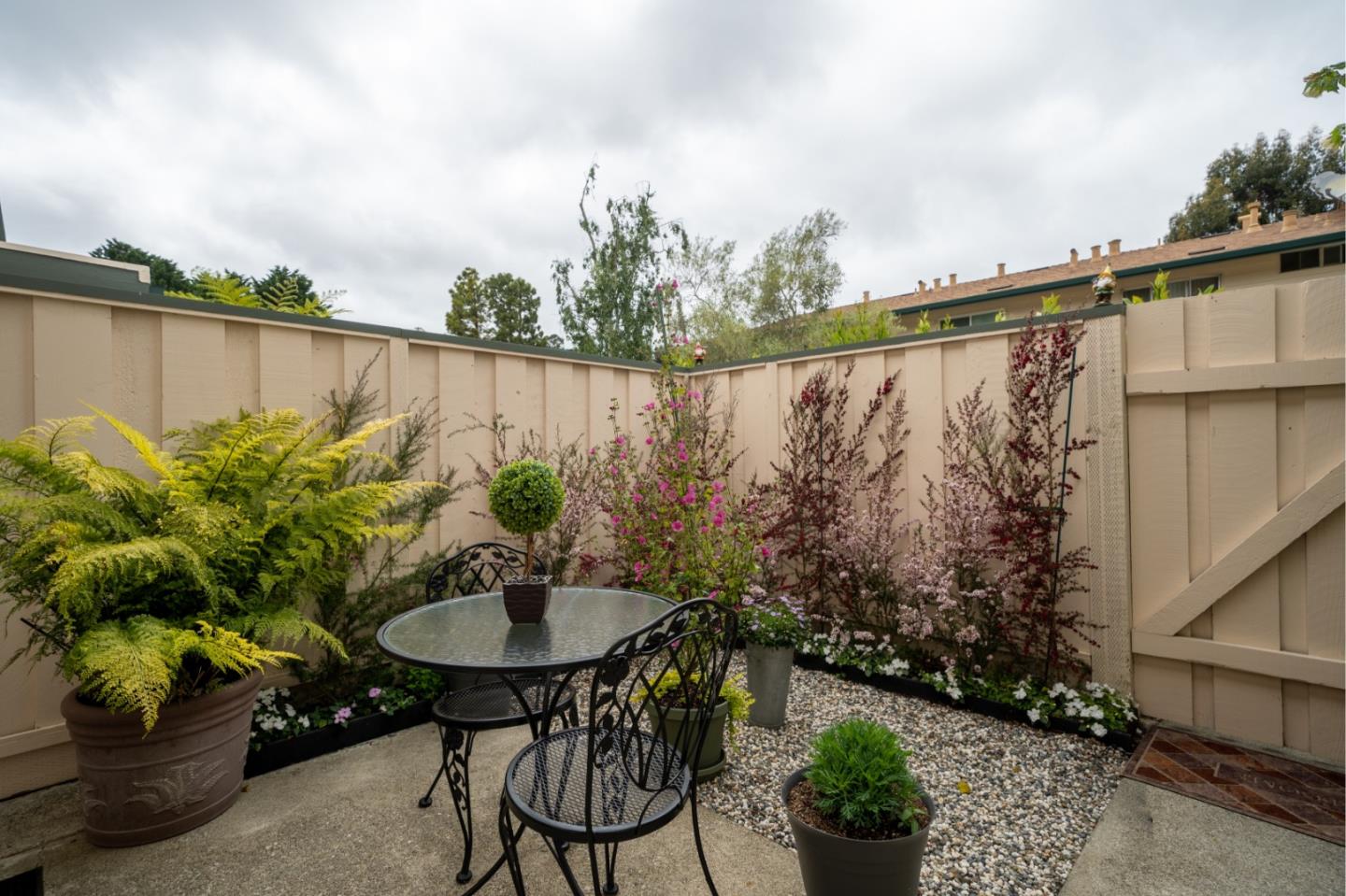 1321 Terra Nova Boulevard Pacifica, CA 94044 - Photo 13 of 39 a backyard with a table and chairs with potted plants