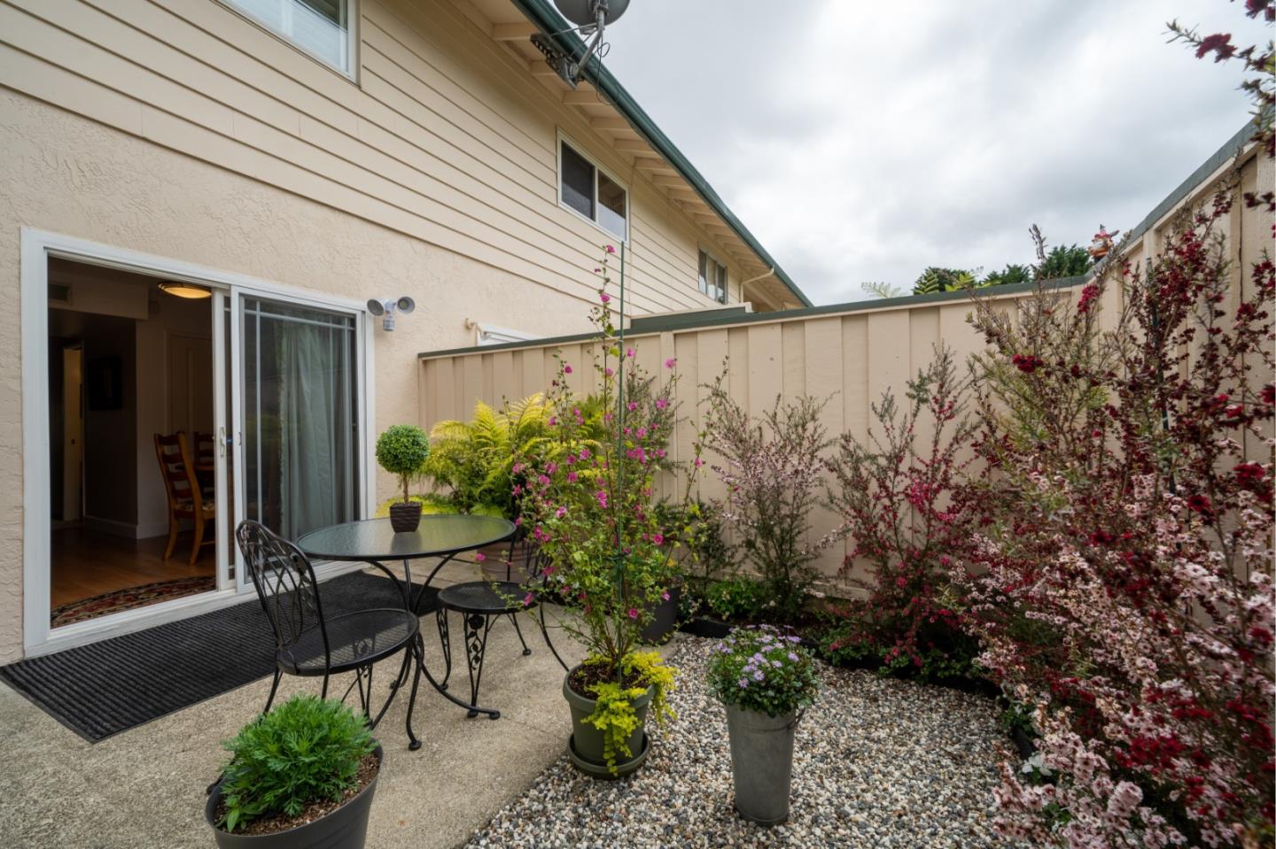 1321 Terra Nova Boulevard Pacifica, CA 94044 - Photo 14 of 39 a backyard with table and chairs with potted plants
