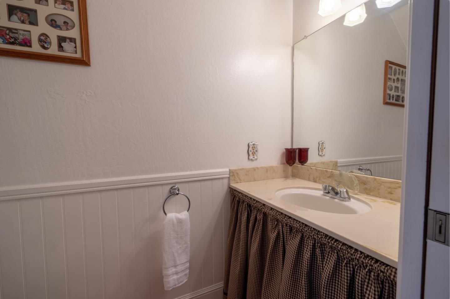 1321 Terra Nova Boulevard Pacifica, CA 94044 - Photo 17 of 39 a bathroom with a sink and a mirror