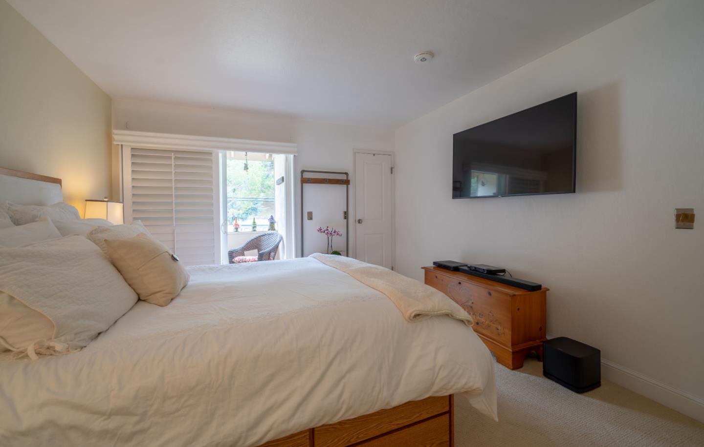 1321 Terra Nova Boulevard Pacifica, CA 94044 - Photo 33 of 39 a bedroom with a bed and a flat screen tv