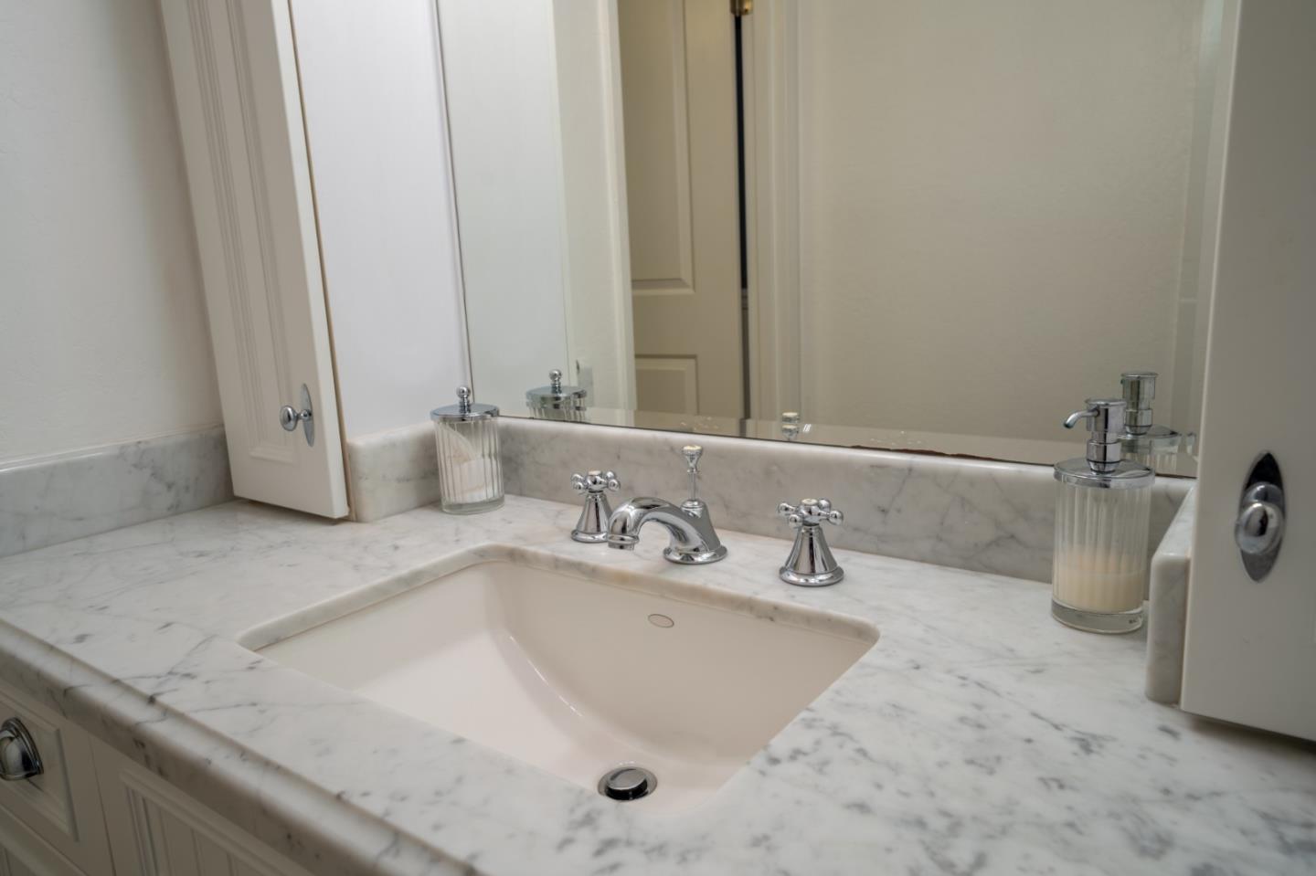 1321 Terra Nova Boulevard Pacifica, CA 94044 - Photo 35 of 39 a bathroom with a granite countertop sink and a mirror