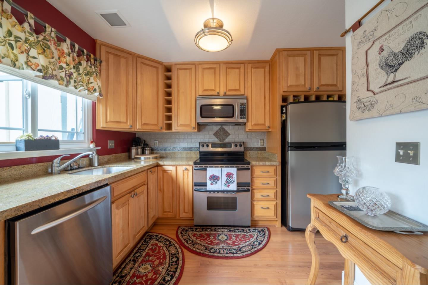 1321 Terra Nova Boulevard Pacifica, CA 94044 - Photo 6 of 39 a kitchen with stainless steel appliances granite countertop a stove a sink and a microwave