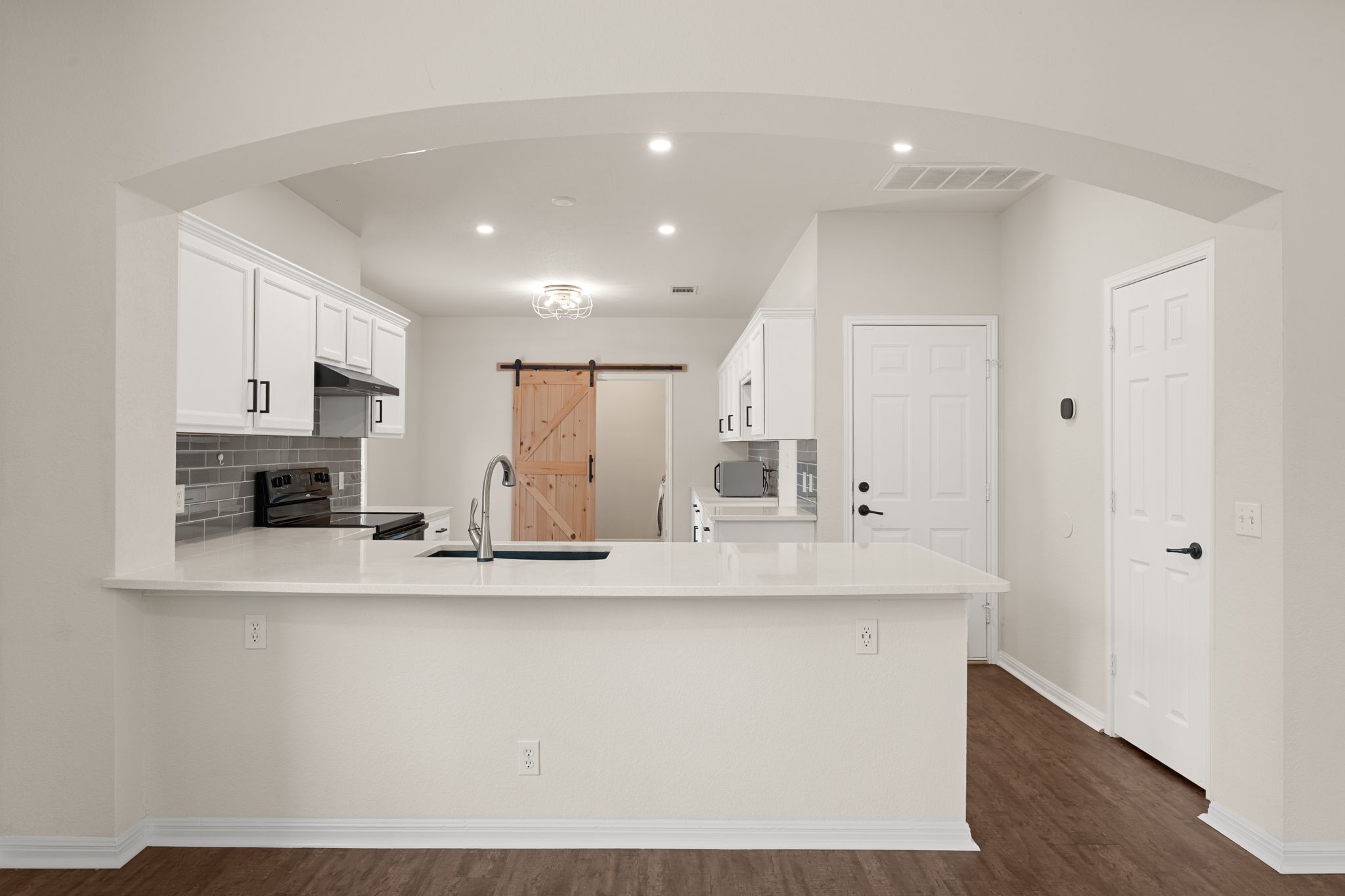 8902 Magna Carta Loop, Unit 122 Austin, TX 78754 - Photo 8 of 39 A well-appointed kitchen showcasing white cabinetry, ample counter space, and modern fixtures.