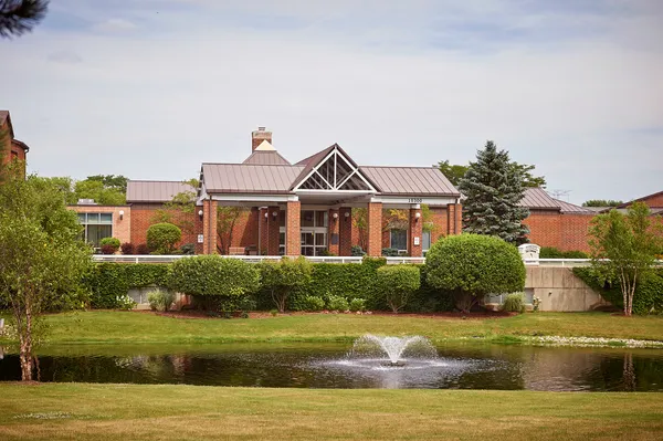 a front view of house with yard and lake view