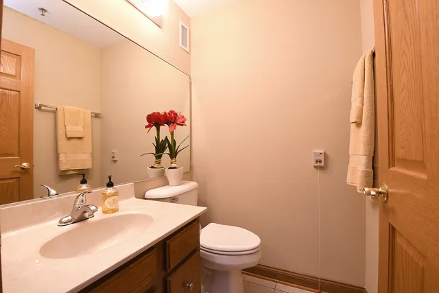 a bathroom with a sink toilet and a mirror