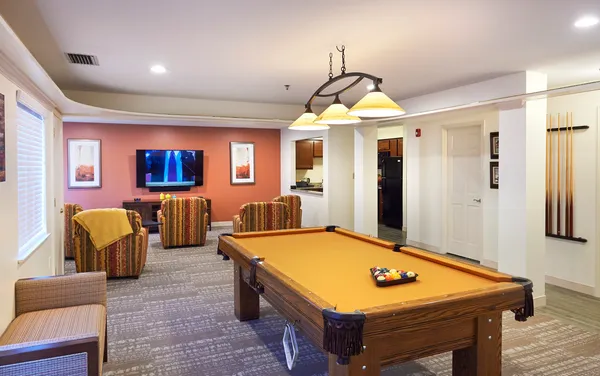 a room with pool table and windows