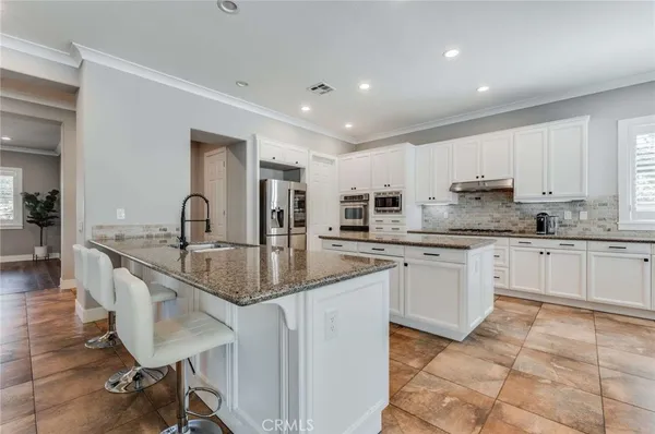 a kitchen with stainless steel appliances granite countertop a sink and cabinets