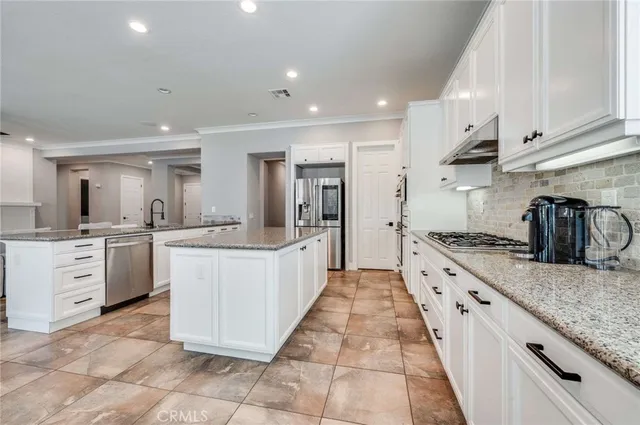 a large kitchen with stainless steel appliances lots of counter space sink and cabinets