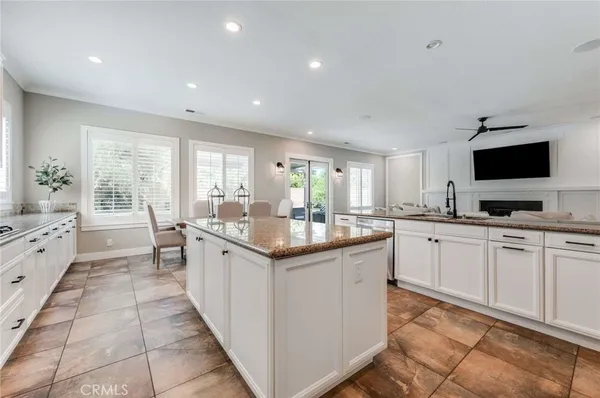 a kitchen with granite countertop a sink and white appliances