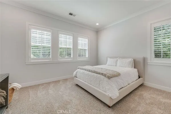 a bedroom with a bed lamp and window