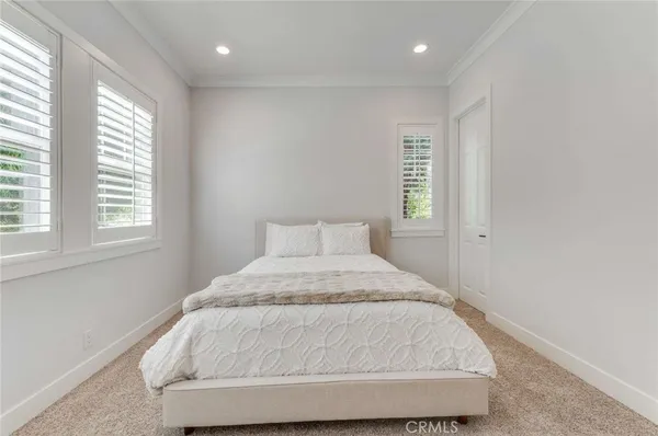 a bed sitting in a bedroom next to a window