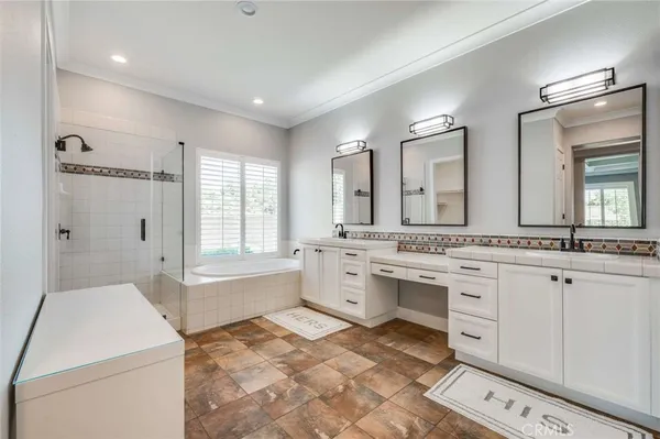 a large white bathroom with a granite countertop sink mirror and a bathtub