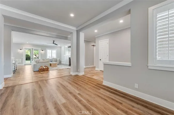 a view of a room with wooden floor and furniture