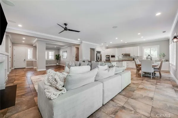 a living room with furniture and view of kitchen