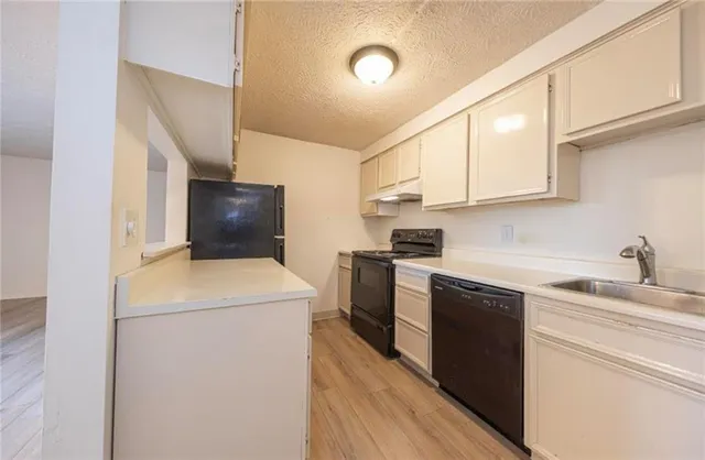 a kitchen with a sink stove and refrigerator