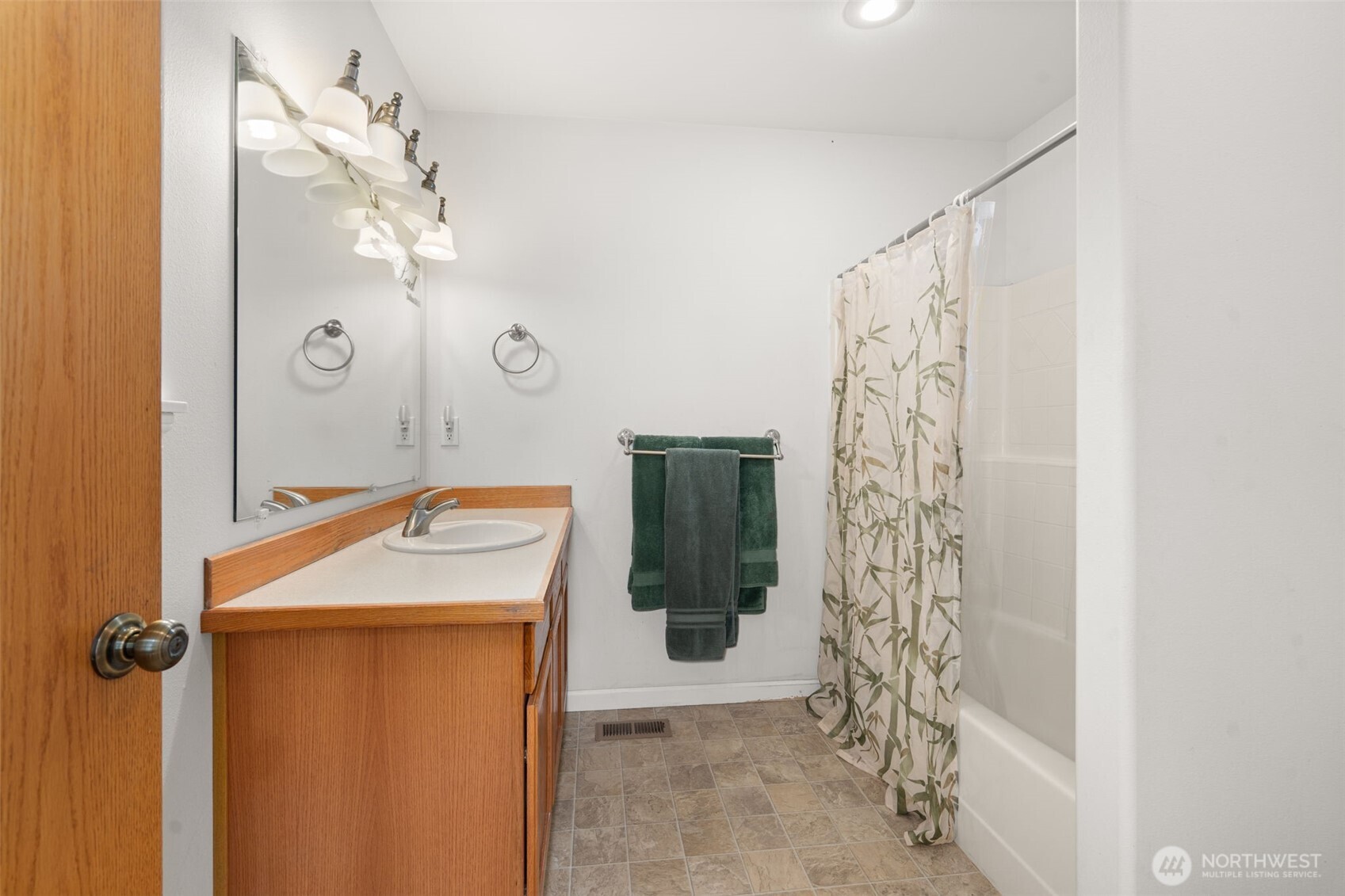 27 Otter Lane Elma, WA 98541 - Photo 21 of 31 a bathroom with a granite countertop sink a mirror and shower curtain