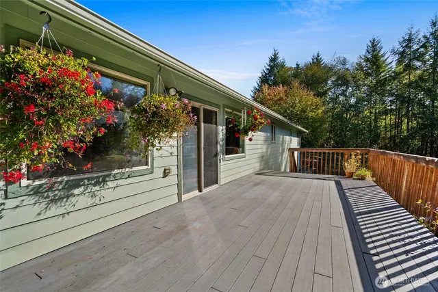 a balcony with flowers and wooden floor