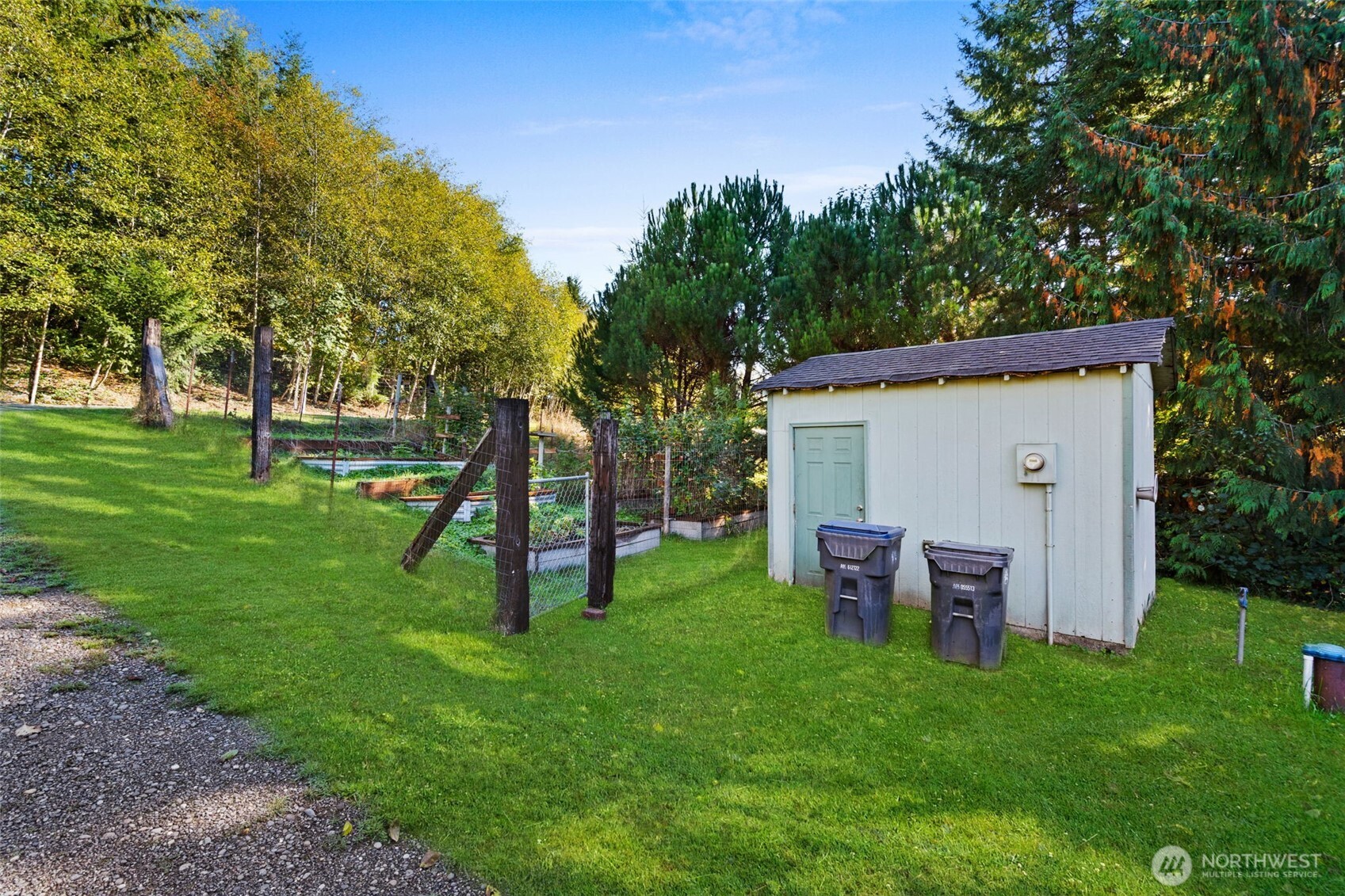 27 Otter Lane Elma, WA 98541 - Photo 28 of 31 a view of a backyard with table and chairs a barbeque and a large tree