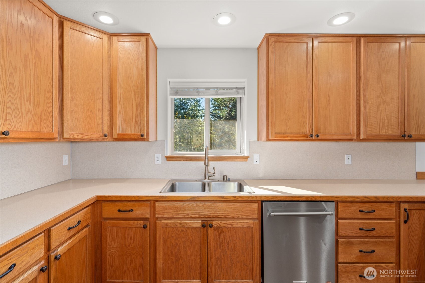 27 Otter Lane Elma, WA 98541 - Photo 7 of 31 a kitchen with stainless steel appliances a sink dishwasher and cabinets with wooden floor