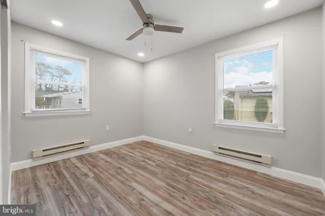a view of wooden floor and windows in a room